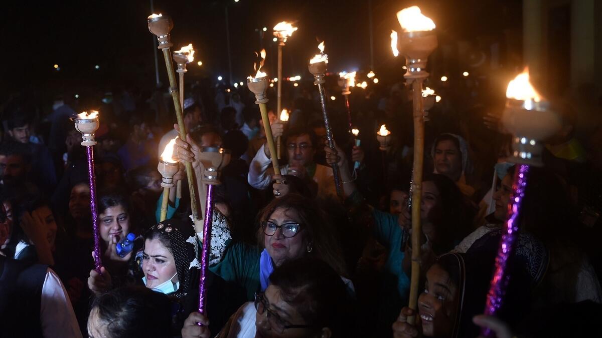 People hold torch lights during Independence Day celebrations in Karachi on August 14, 2020, as Pakistan celebrates its 74th anniversary of independence from British rule. Photo: AP