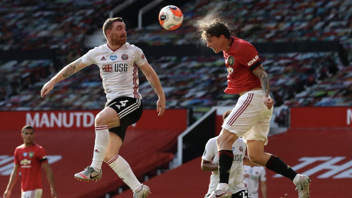 Manchester United's Victor Lindelof jump for the ball during the English Premier League soccer match between Manchester United and Sheffield United at Old Trafford in Manchester, England. Photo: AP