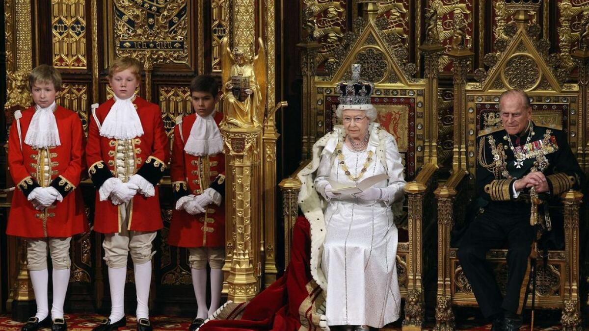 Britains Queen Elizabeth II (L) sits next to Prince Philip, Duke of Edinburgh (R), on the throne in the Chamber of the House of Lords as she reads the Queens Speech.