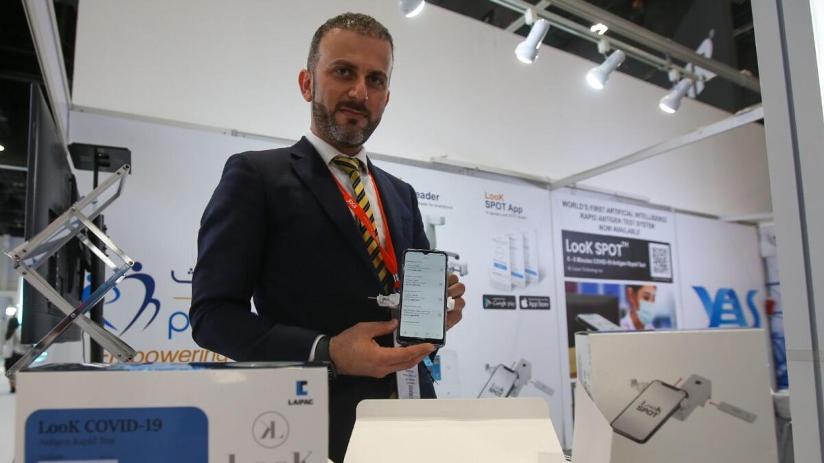 A representative displays the AI-powered Covid-19 antigen test kit during the International Defence Exhibition in Abu Dhabi. KT Photo: Ryan Lim