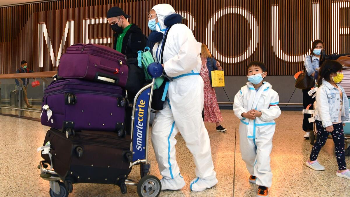 International travellers wearing personal protective equipment (PPE) arrive at Melbourne's Tullamarine Airport on November 29, 2021 as Australia records it's first cases of the Omicron variant of Covid-19. (Photo: AFP)