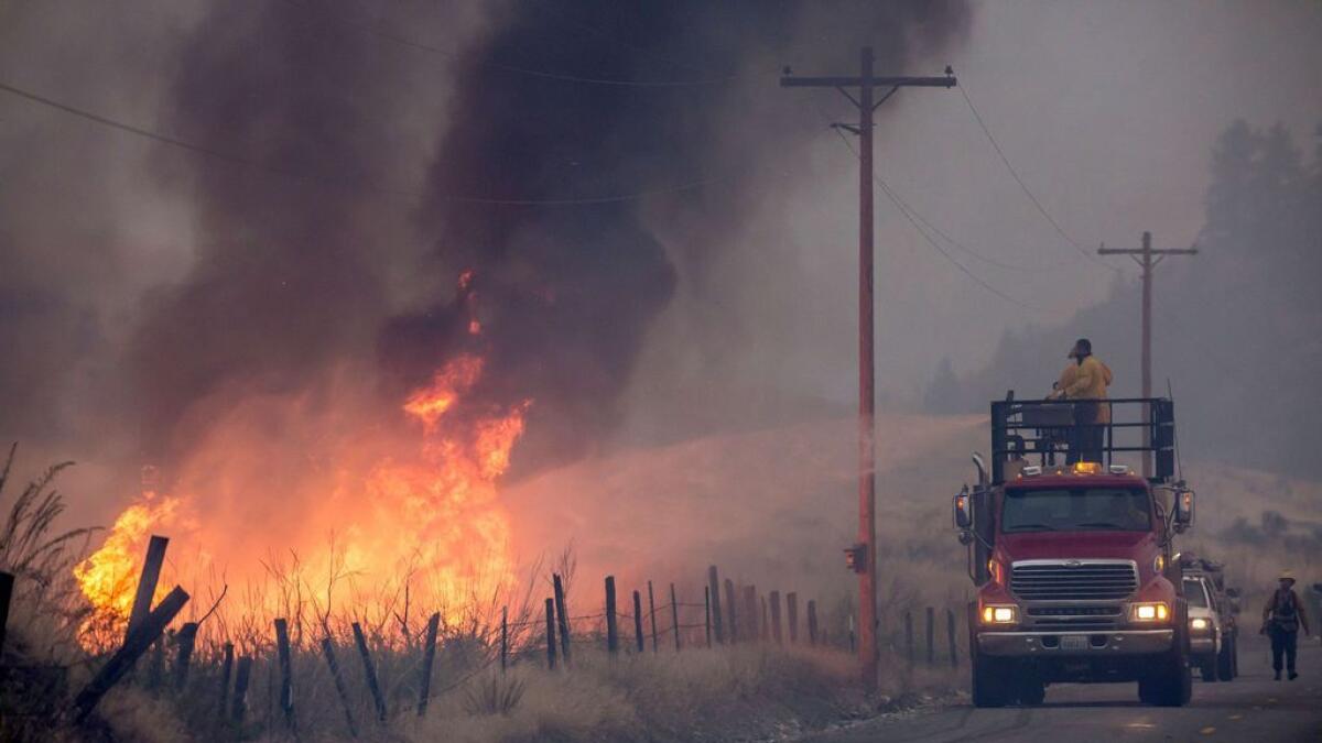 A makeshift fire truck puts water on a wildfire near Omak, Washington.