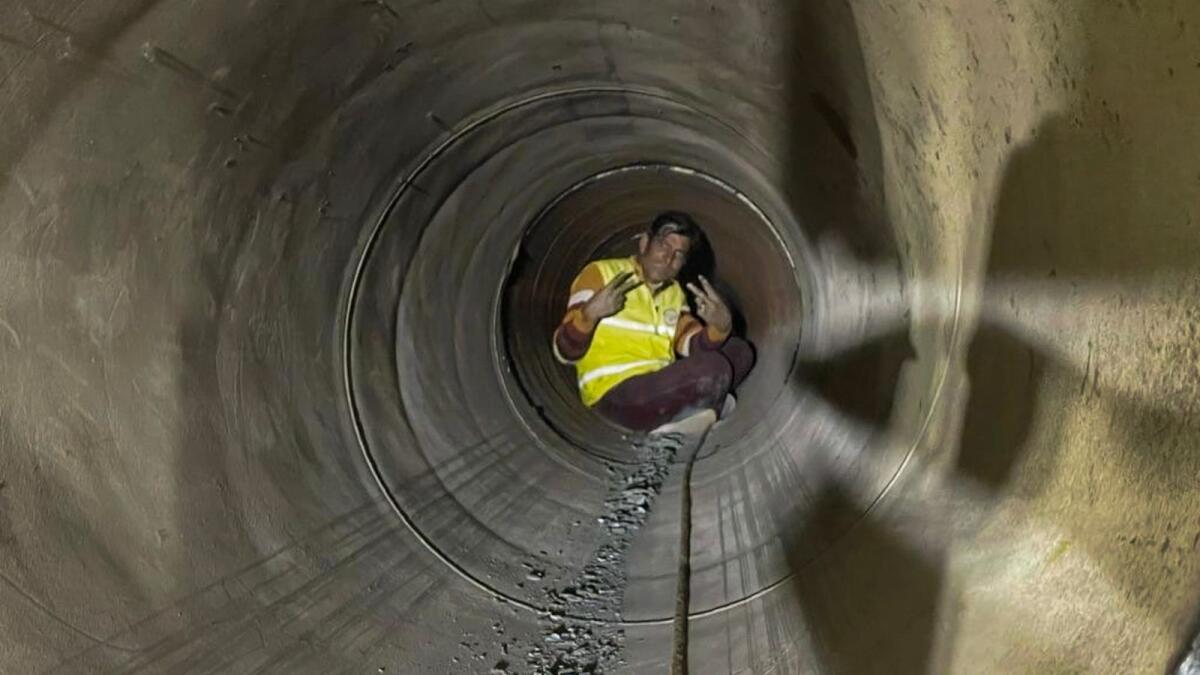 A worker comes out through a pipe inserted to rescue 41 workers from the collapsed Silkyara Tunnel, in Uttarkashi district on Tuesday. — PTI