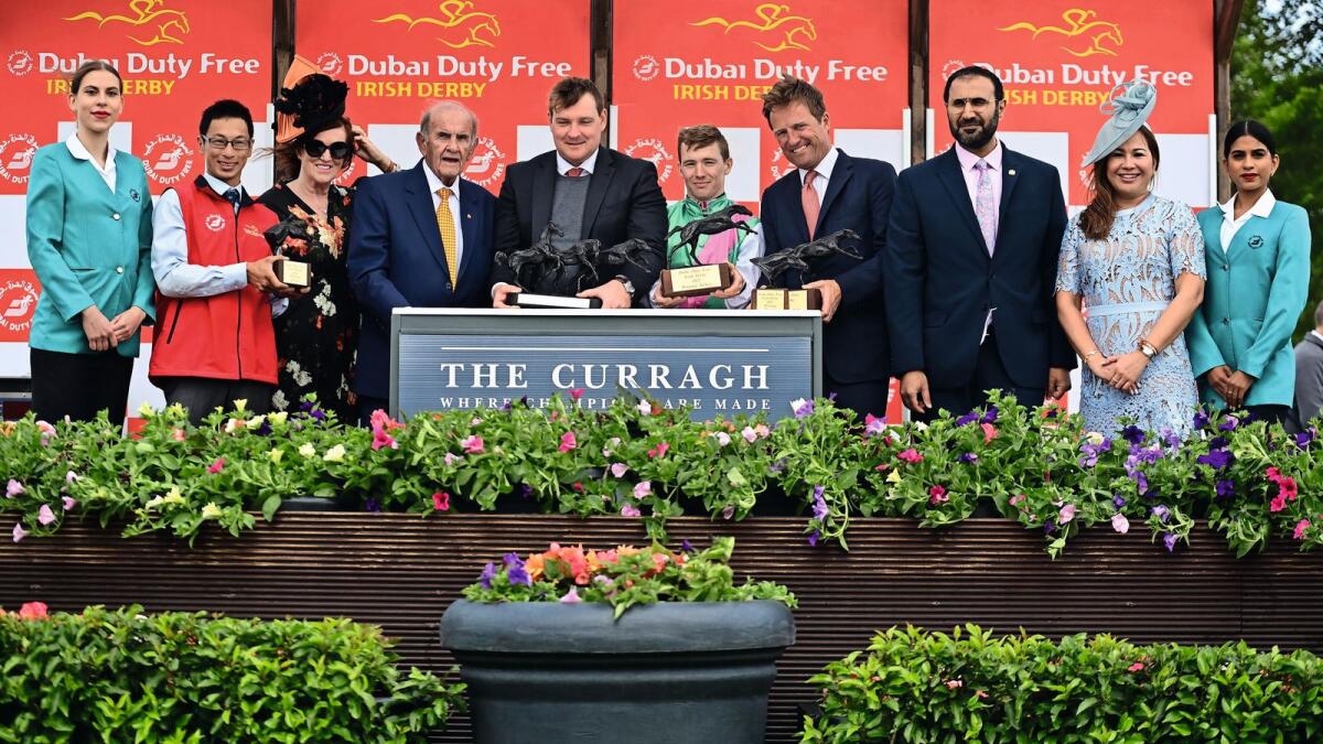 DDF Executive Vice Chairman &amp; CEO, Colm McLoughlin and Sinead El Sibai, SVP - Marketing along with Mohammed Hmoud Hamad Rahma Al Shamsi, UAE Charge D’Affaires, presenting the trophies to the winning connections of Barry Mahon, Juddmonte’s general manager of Ireland and European racing, trainer Ralph Beckett and jockey Colin Keane after ‘Westover’ won the 2022 Dubai Duty Free Irish Derby. Also, in the photo is Jasmin Micoyco, Manager - Projects &amp; Events and ‘Westover’s groom Chun Lee.