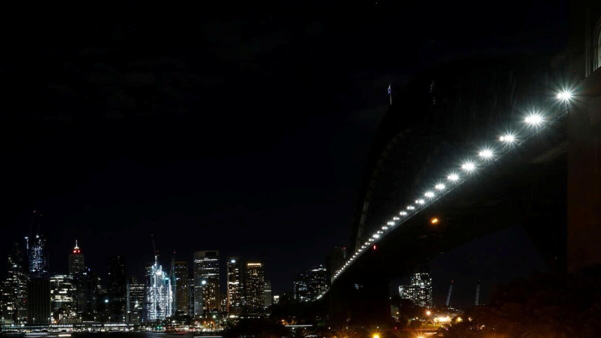 The Sydney Harbour Bridge is seen after its lights were switched off during the Earth Hour 2021 celebrations, in Sydney, Australia.
