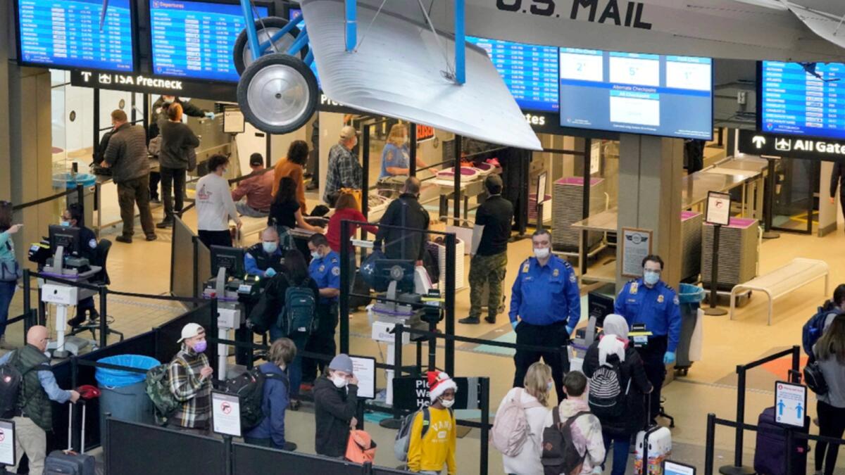 Holiday travelers line up at the security checkpoint check point at Pittsburgh International Airport. — AP