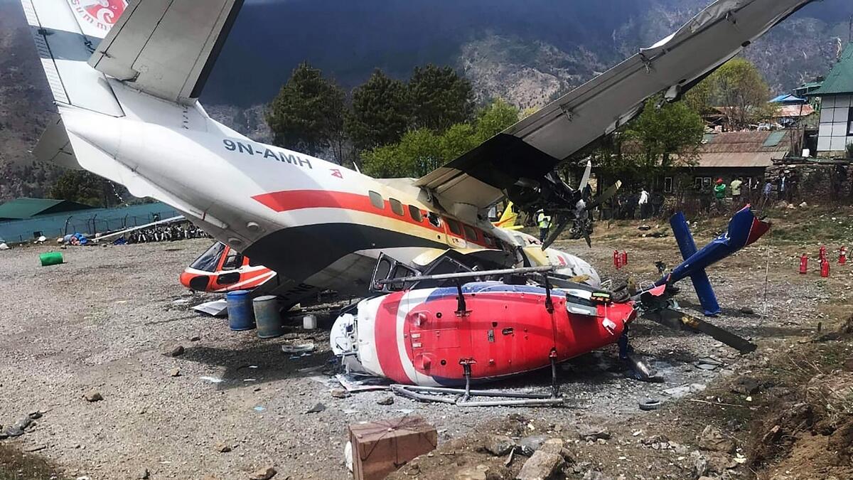 A Summit Air Let L-410 Turbolet aircraft bound for Kathmandu is seen after it hit two helicopters during take off at Lukla airport, the main gateway to the Everest region.-AFP