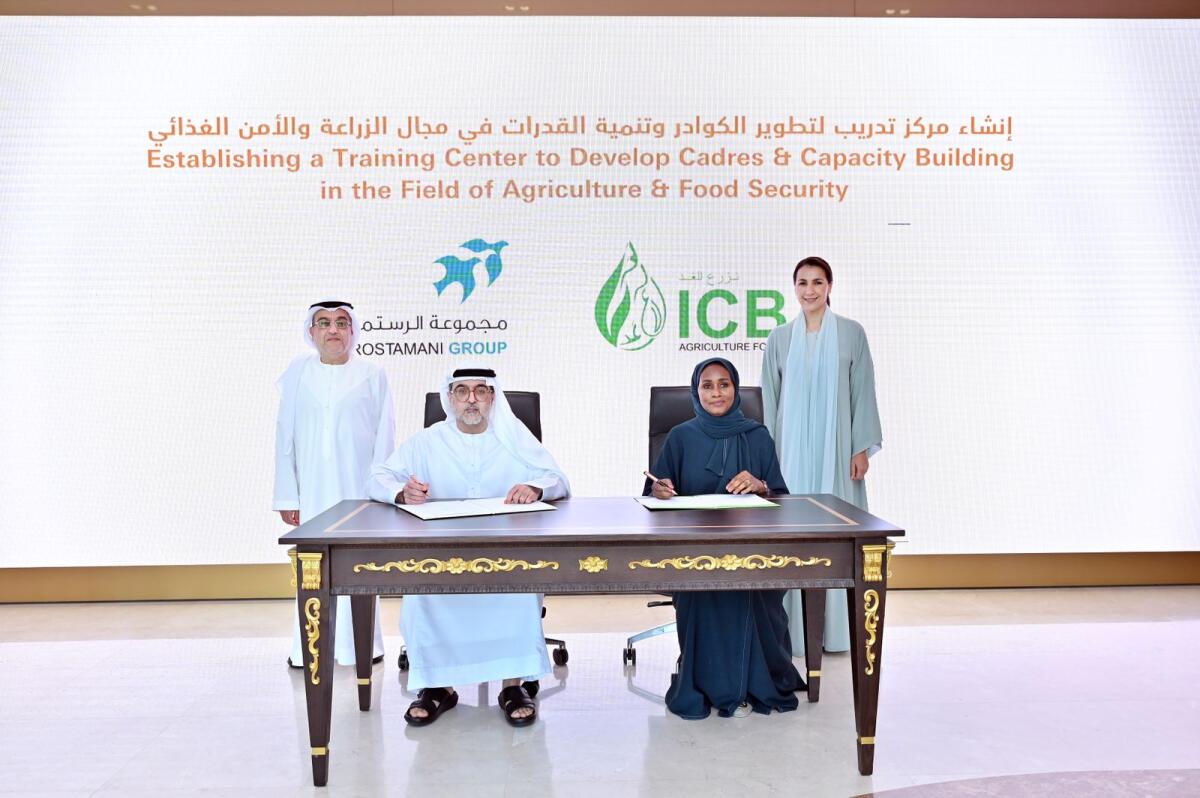 Mariam bint Mohammed Almheiri, UAE Minister of Climate Change and Environment, and Marwan Abdullah Al Rostamani, Chairman, Al Rostamani Group, witnessing the signing of partnership between ICBA and Al Rostamani Group. Dr Tarifa Alzaabi, Director-General of ICBA, and Hassan Abdullah Al Rostamani, Vice-Chairman of the Al Rostamani Group, signed the agreement. — Supplied photo