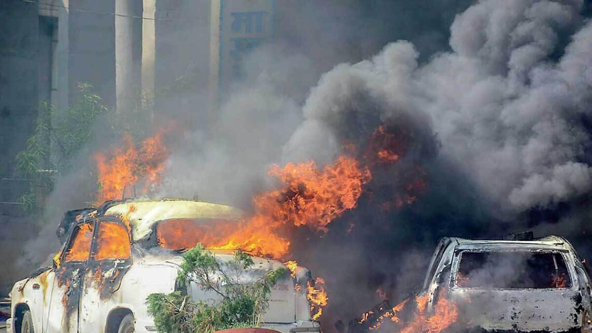 FIERY PROTESTS: Vehicles on fire during the protest against the alleged ‘dilution’ of Scheduled Castes/Scheduled Tribes Act, in Muzzaffarnagar on Monday. — PTI
