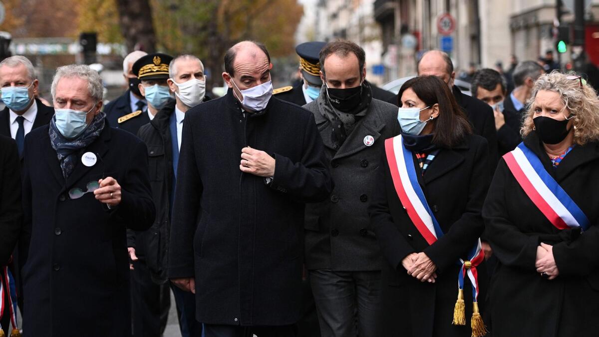 French Prime Minister Jean Castex (2ndL) and others walk towards La Bonne Biere cafe bar on Friday in Paris during ceremonies across Paris marking the fifth anniversary of the terror attacks of November 2015.