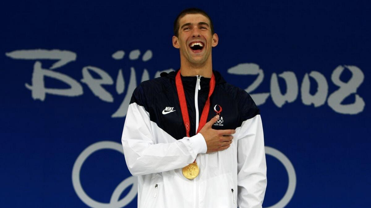 Michael Phelps smiles during the medal presentation ceremony after winning the men's 400m individual medley swimming final at the National Aquatics Center during the Beijing 2008 Olympic Games. - Reuters file