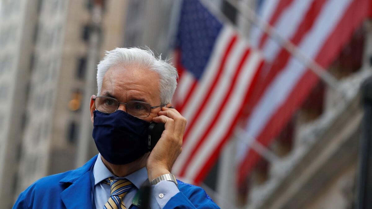 A trader speaks on a phone outside the New York Stock Exchange (NYSE) following Election Day in Manhattan, New York City, U.S., November 4, 2020.