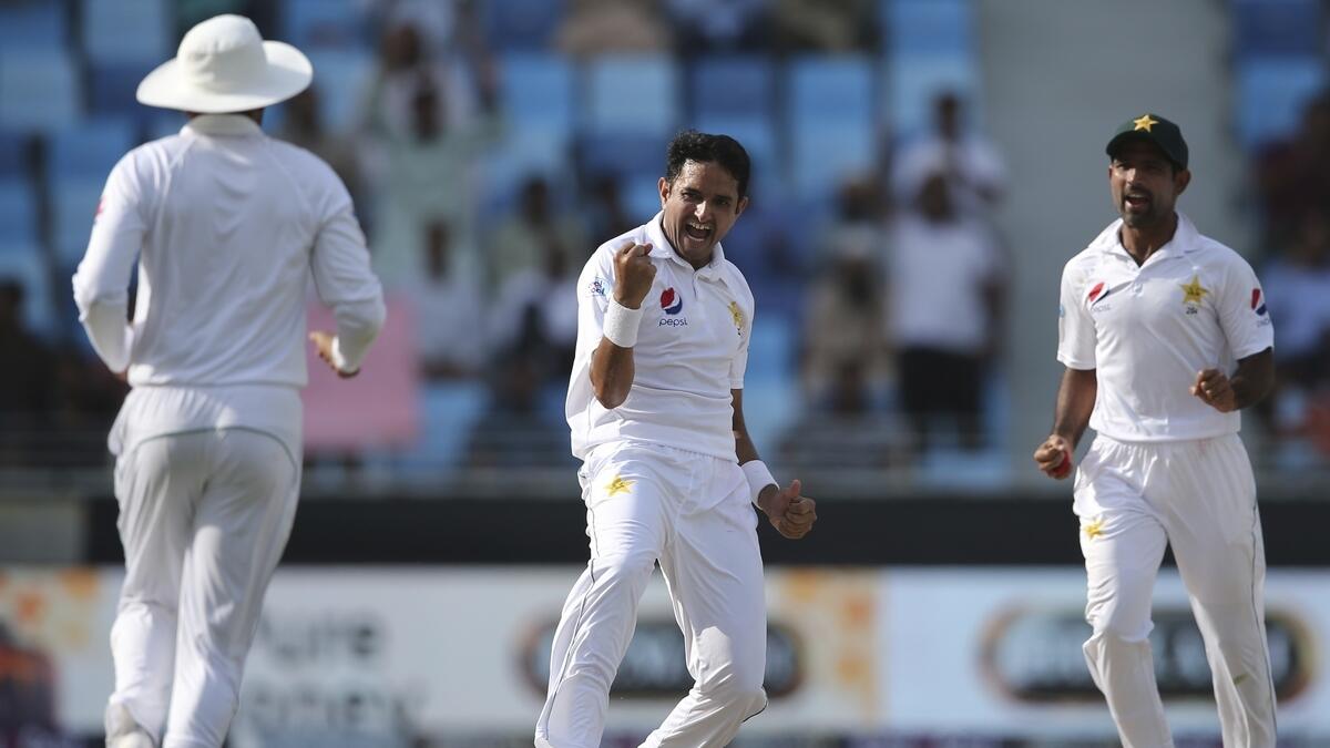 Pakistans Mohammad Abbas, center, celebrates after taking the wicket of Australias Aaron Finch during their test match in Dubai.- AP