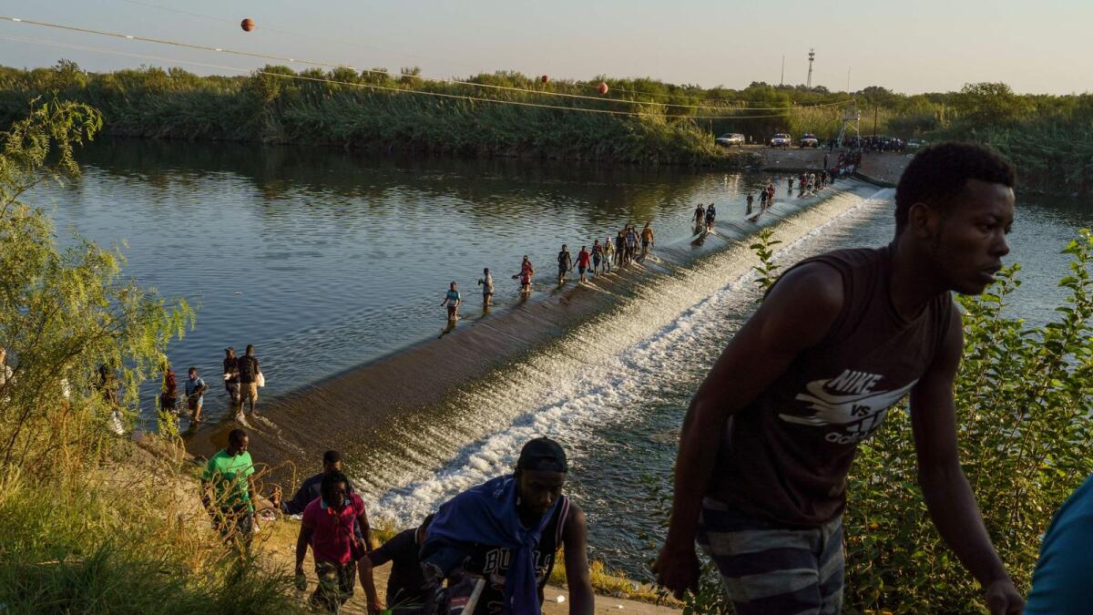 Haitian migrants cross the Rio Grande river to get food and supplies in Coahuila state, Mexico.