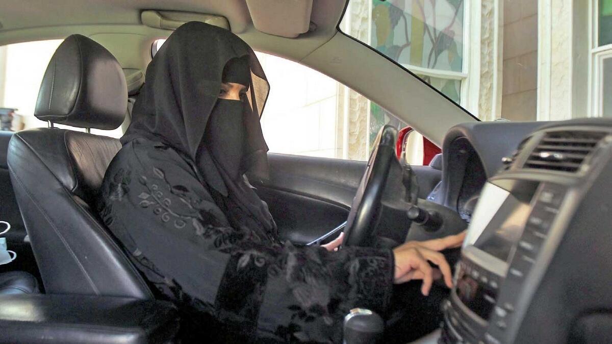 A woman drives a car in Riyadh as part of a campaign for driving. 