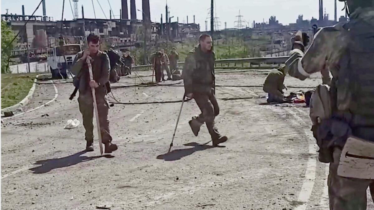 Ukrainian servicemen leave the besieged Azovstal steel plant in Mariupol. — AP