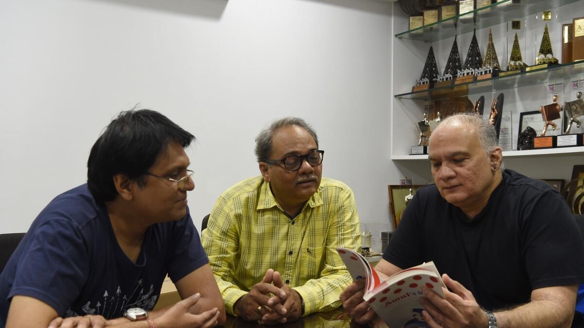 Indian creative head of Amul advertising campaigns Rahul daCunha (R), cartoonist Jayant Rane (C) and copywriter Manish Jhaveri (L) interact during an interview with AFP in Mumbai.