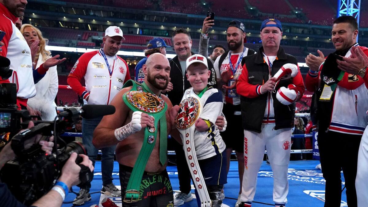 Tyson Fury with Marshall Janson as he celebrates after beating Dillian Whyte to win their WBC heavyweight title boxing fight. (AP)