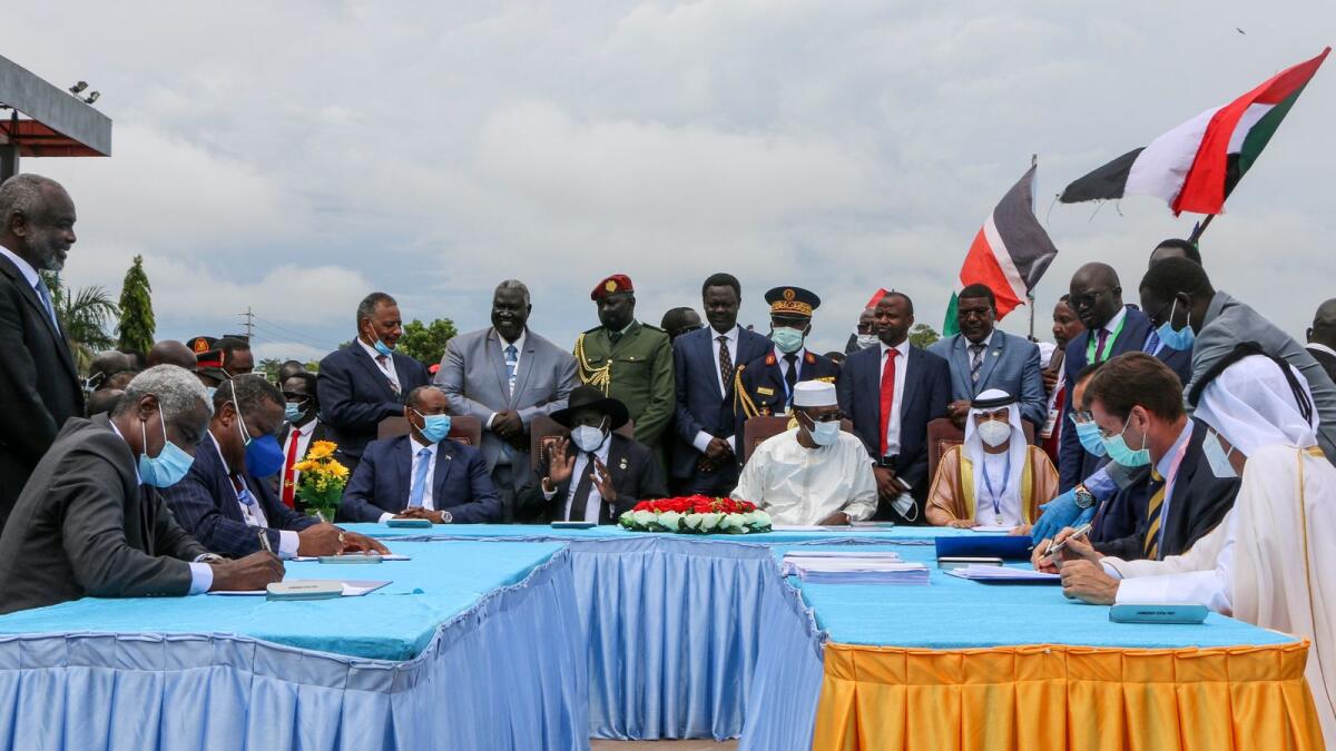 Gen. Abdel Fattah Burhan, seated centre-left, President of South Sudan Salva Kiir, seated centre, and President of Chad Idriss Deby, seated centre-right, attend a ceremony to sign a peace deal between Sudan's transitional authorities and a rebel alliance, in Juba, South Sudan, on Oct. 3, 2020.