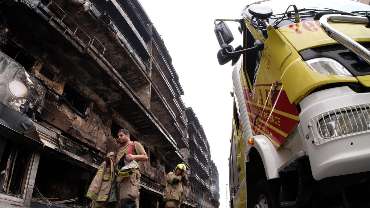 Firefighters continue operations after a huge fire broke out in a residential building in Muraqqabat area on Monday evening. Photos: Shihab/Khaleej Times