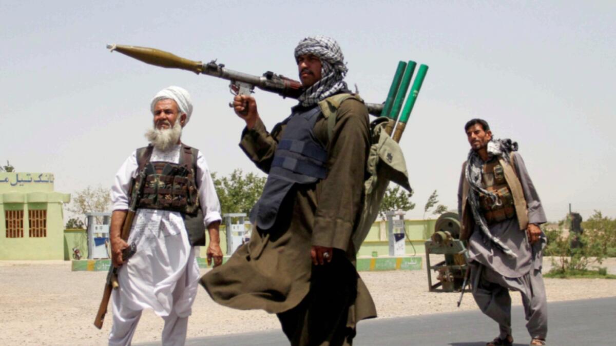 Former Mujahideen hold weapons to support Afghan forces in their fight against Taleban on the outskirts of Herat province. — Reuters