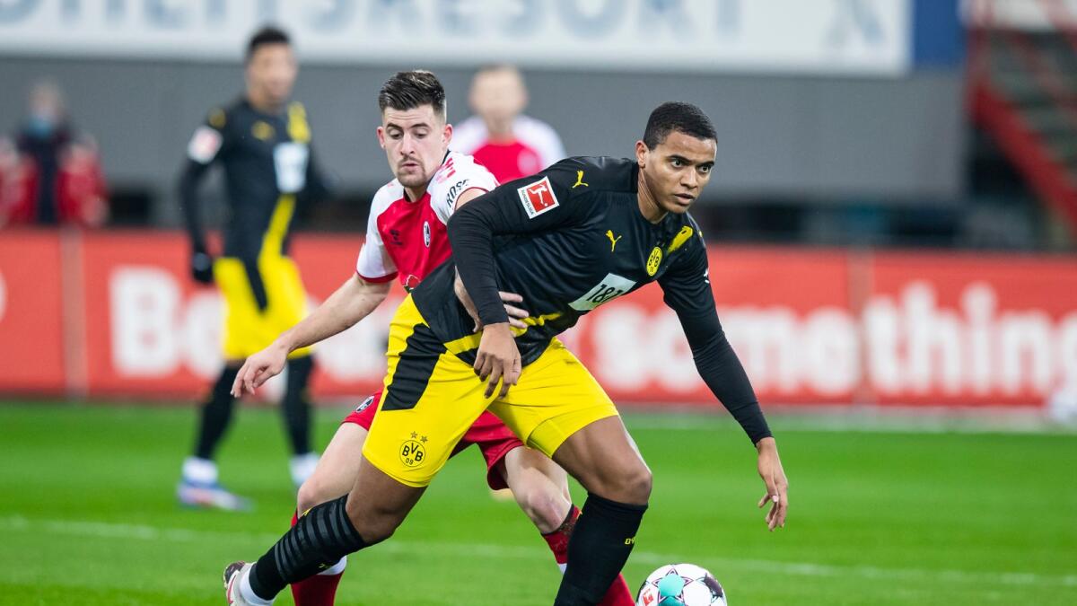 Freiburg's Baptiste Santamaria (left) and Dortmund's Manuel Akanji challenge for the ball. — AP