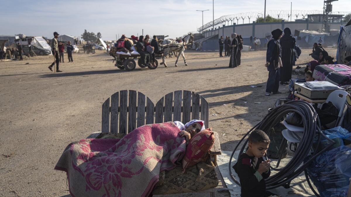 Palestinians displaced by the Israeli bombardment of the Gaza Strip gather at a tent camp in Rafah. - AP