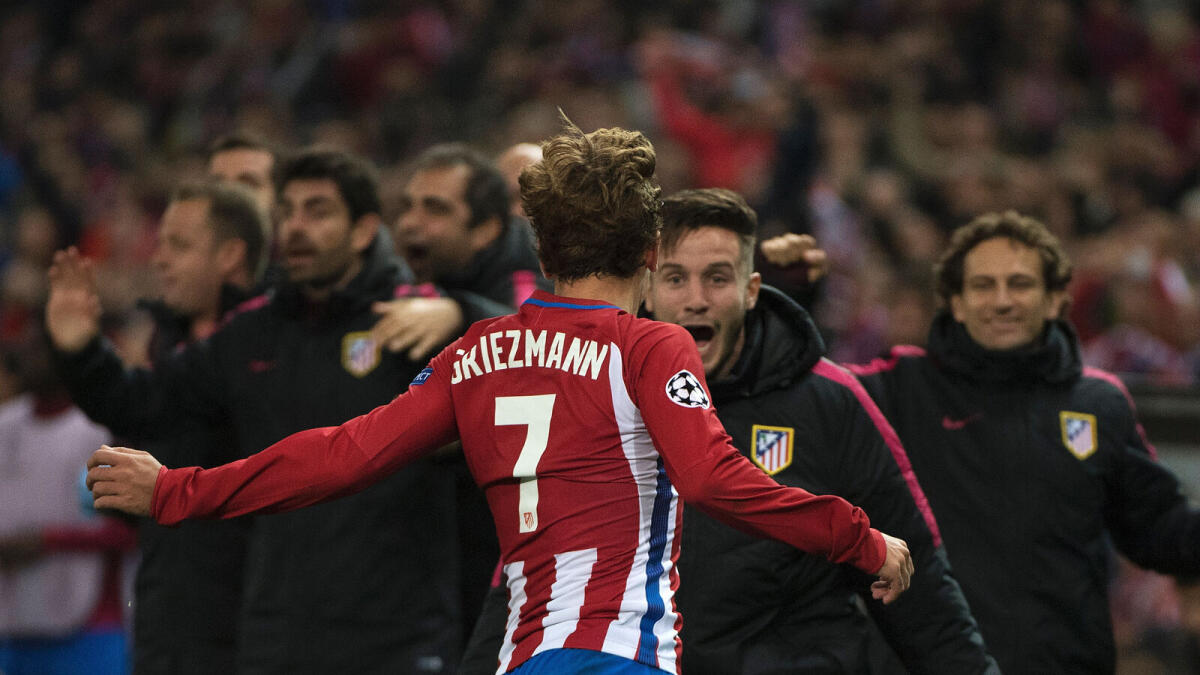 Atletico Madrid's French forward Antoine Griezmann (front) celebrates with teammates after scoring a second goal during the UEFA Champions League Group D football match Club Atletico de Madrid vs FC Rostov at the Vicente Calderon stadium in Madrid, on November 1, 2016. AFP