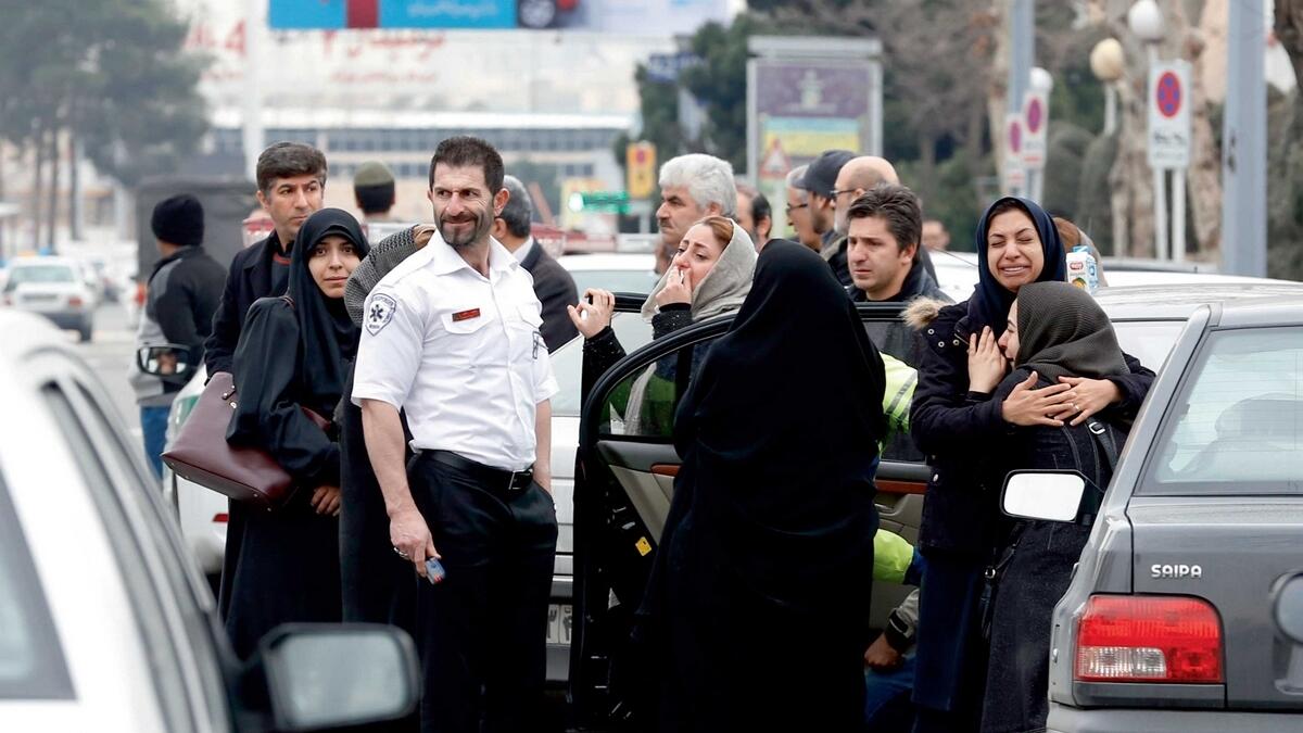 Relatives of passengers, onboard the Aseman Airlines flight EP3704, react as they gather near Tehran’s Mehrabad airport. — AFP