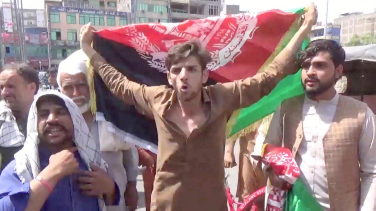 People carry Afghan flags as they take part in an anti-Taliban protest in Jalalabad. — Reuters