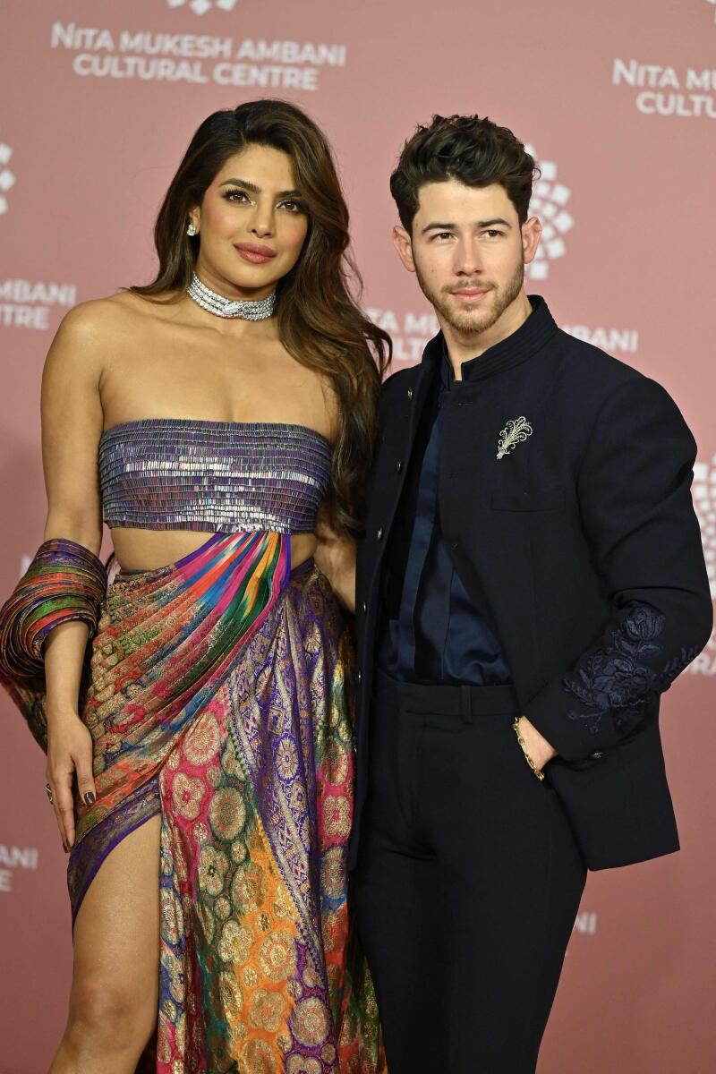 Chopra turned heads in a multi-coloured thigh-high slit gown while hubby Nick Jonas opted for a classic black suit.
