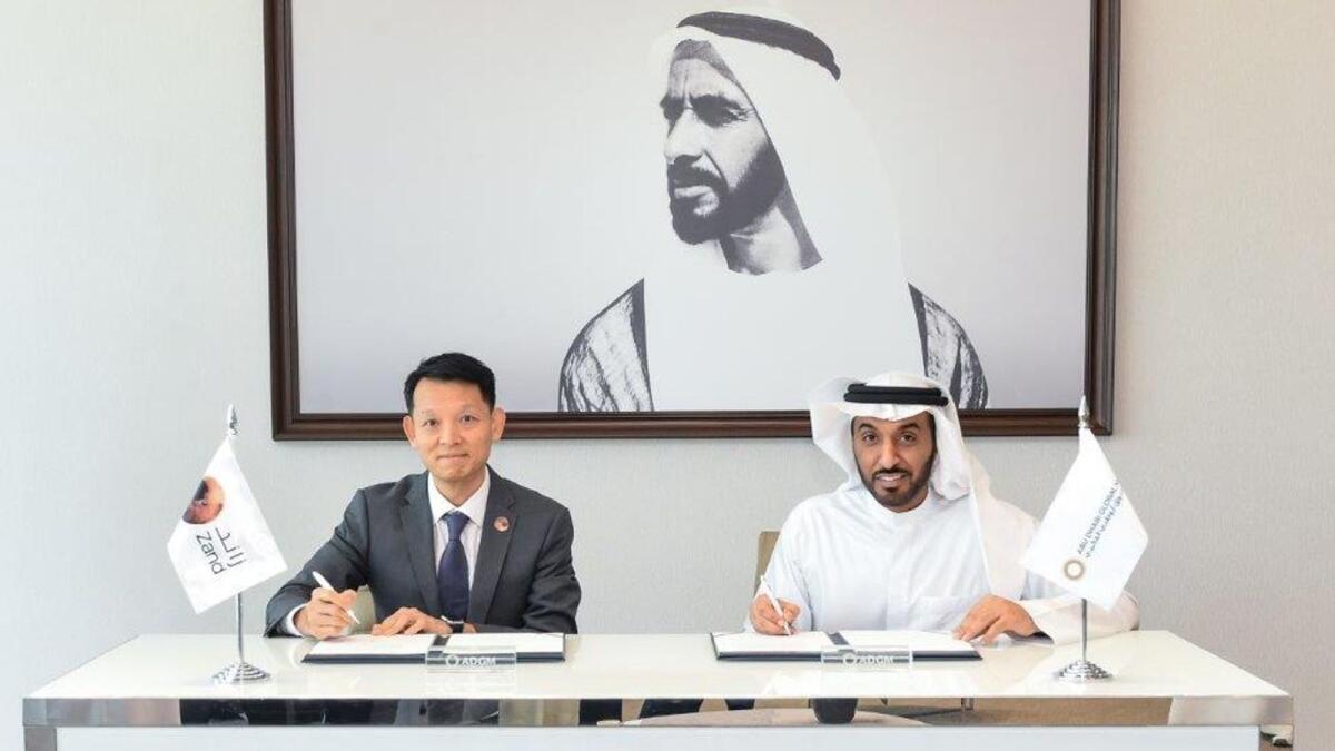 Dhaher bin Dhaher Al Mheiri and Michael Chan signing the deal to support SMEs in Abu Dhabi. — Supplied photo