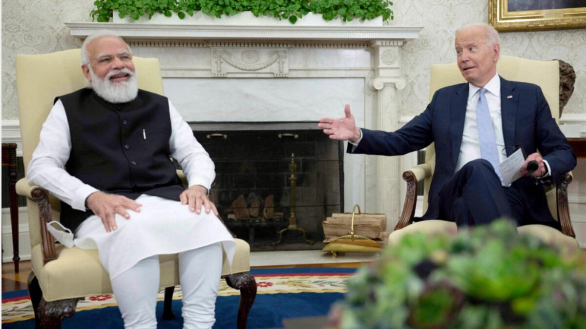 Joe Biden shares a light moment with Indian Prime Minister Narendra Modi  in the Oval Office of the White House. — AFP