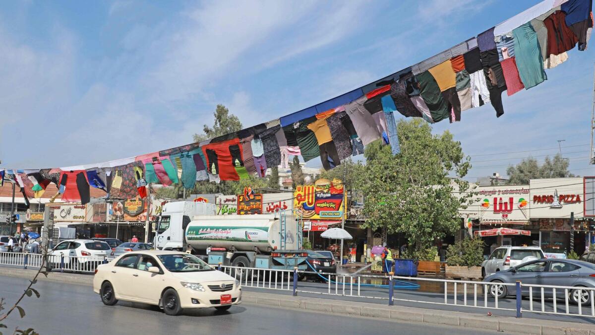 Cars pass beneath an artwork by Iraqi visual artist Tara Abdallah, hanging above a highway in the city of Sulaimaniyah in Iraq's autonomous northern Kurdish region, on Monday.