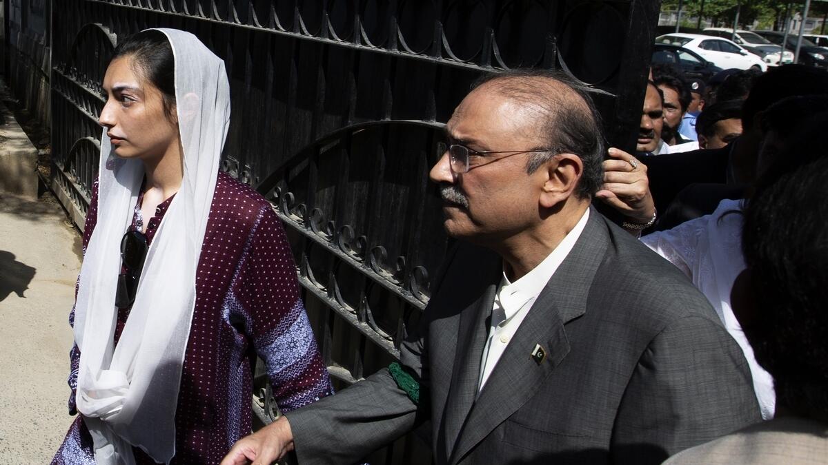 Former Pakistani president and leader of Pakistan Peoples party, Asif Ali Zardari, center, leaves the High Court building with his daughter Asifa Bhutto Zardari, in Islamabad, Pakistan.-AP