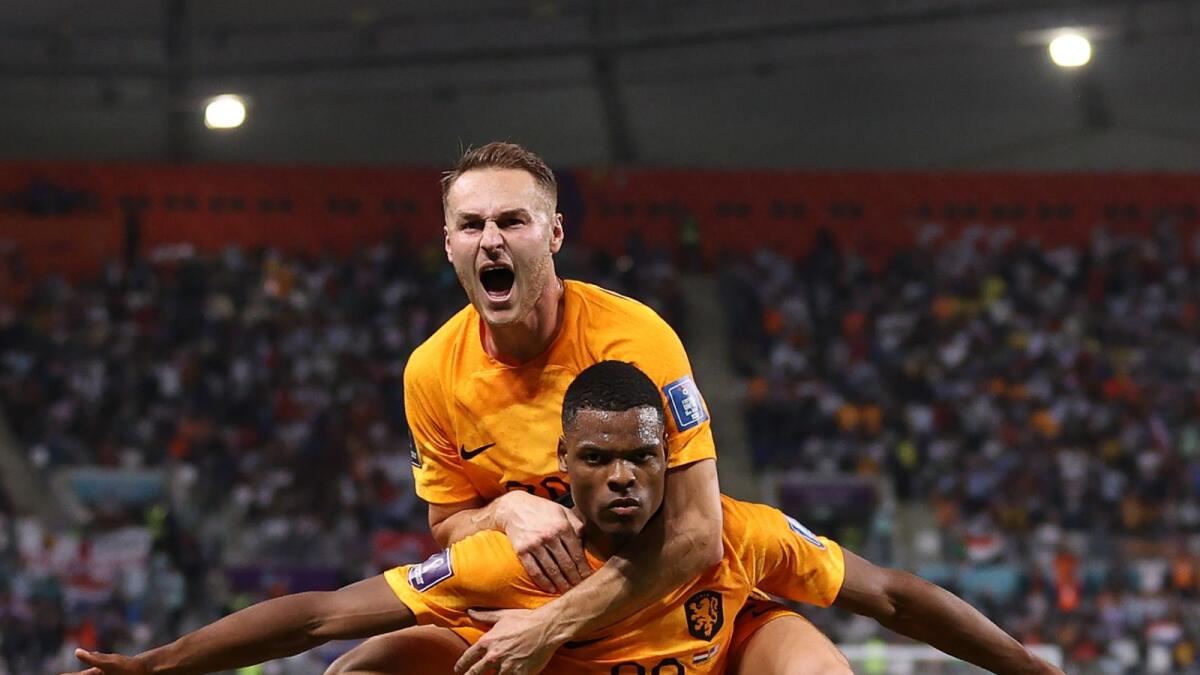 Netherlands' defender Denzel Dumfries celebrates with midfielder Teun Koopmeiners after scoring his team's third goal during the World Cup round of 16 football match against USA at Khalifa International Stadium in Doha.–AFP