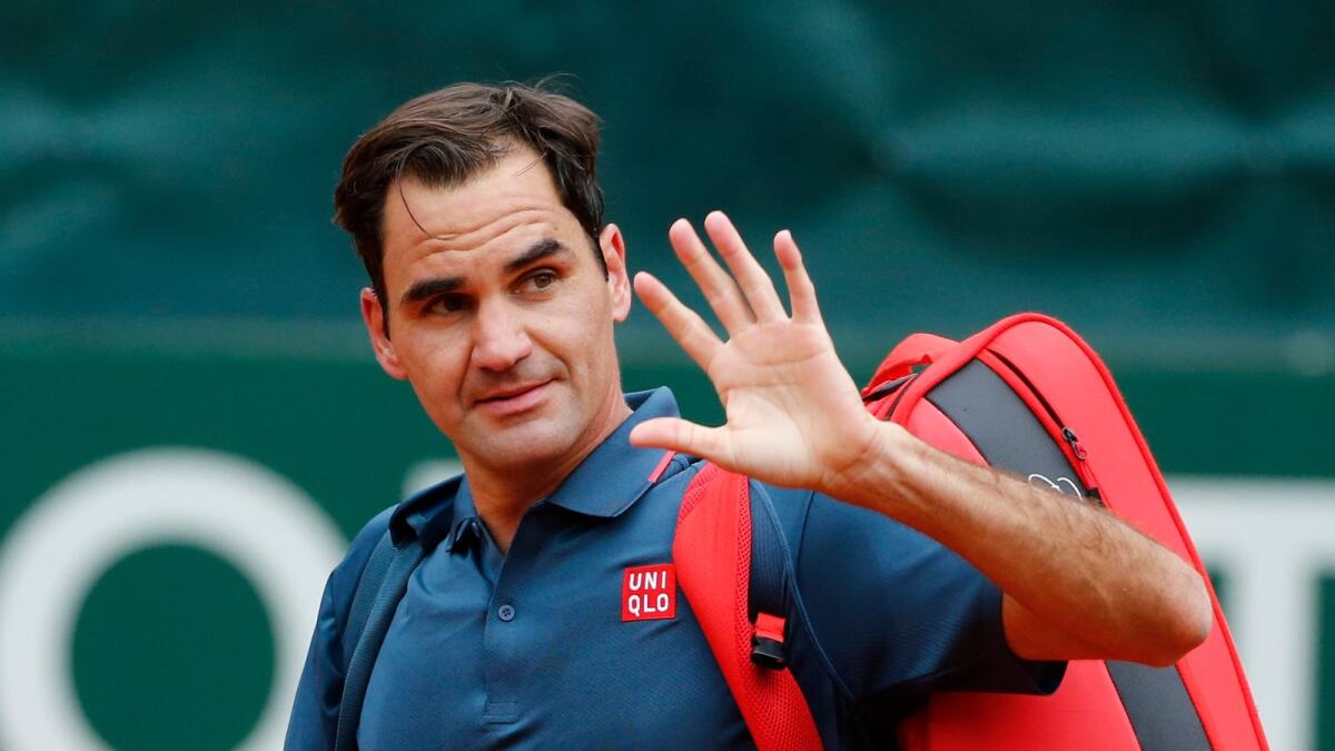 Roger Federer waves to fans after losing his round of 16 match against Pablo Andujar. (Reuters)