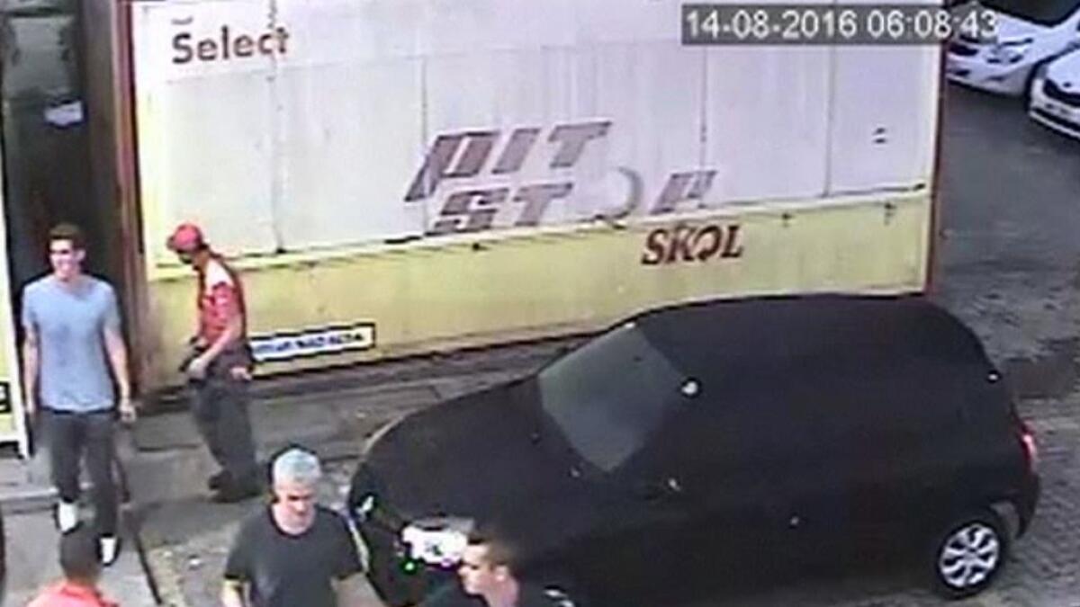 A frame from surveillance video released by Brazil Police, swimmer Ryan Lochte, second from right, of the United States, and teammates, appear at a gas station during the 2016 Summer Olympics in Rio de Janeiro, Brazil. AP
