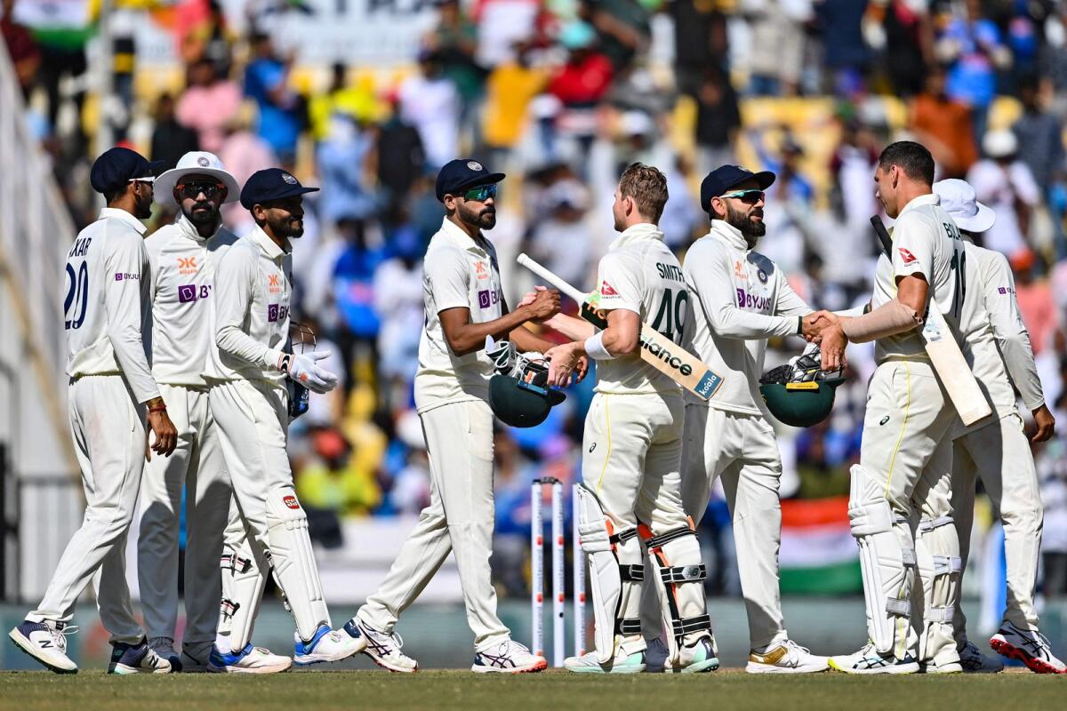 Indian players shake hands with Australian players after the first Test in Nagpur. — AFP