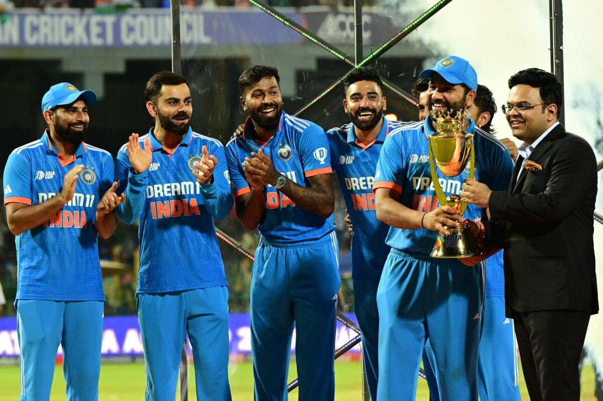 India's captain Rohit Sharma (2R) receives the winning trophy. Photo: AFP