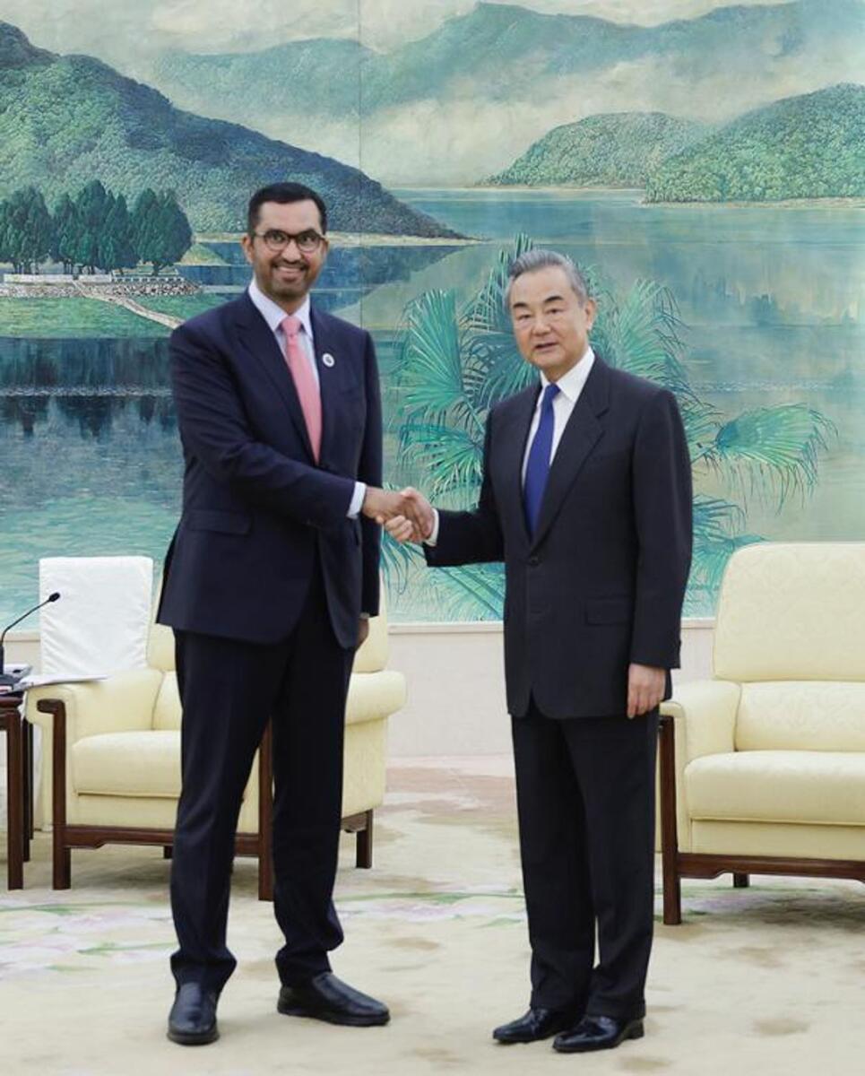 Dr Sultan Al Jaber with Chinese Foreign Minister Wangi Yi.— Photo: Wam