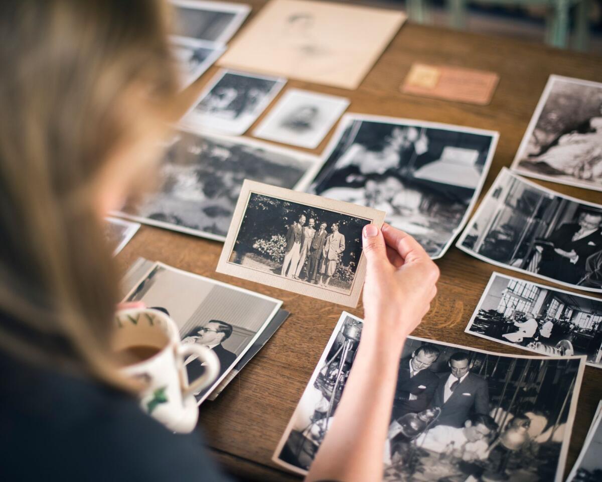 The author looking through archival photos