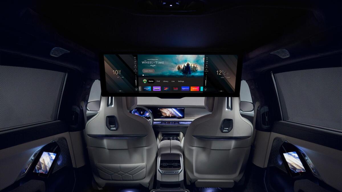 In an undated image provided by BMW, back-seat passengers in BMW’s i7 sedan can watch movies on a 31-inch screen. (BMW via The New York Times)