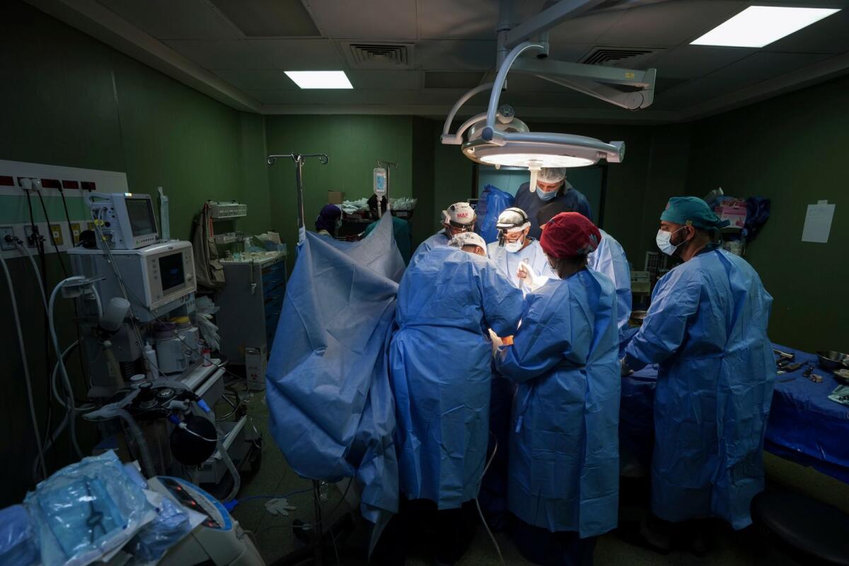 Doctors perform surgery on a patient at Al Aqsa Martyrs Hospital in Deir Al Balah, central Gaza on  March 17, 2024. — AP