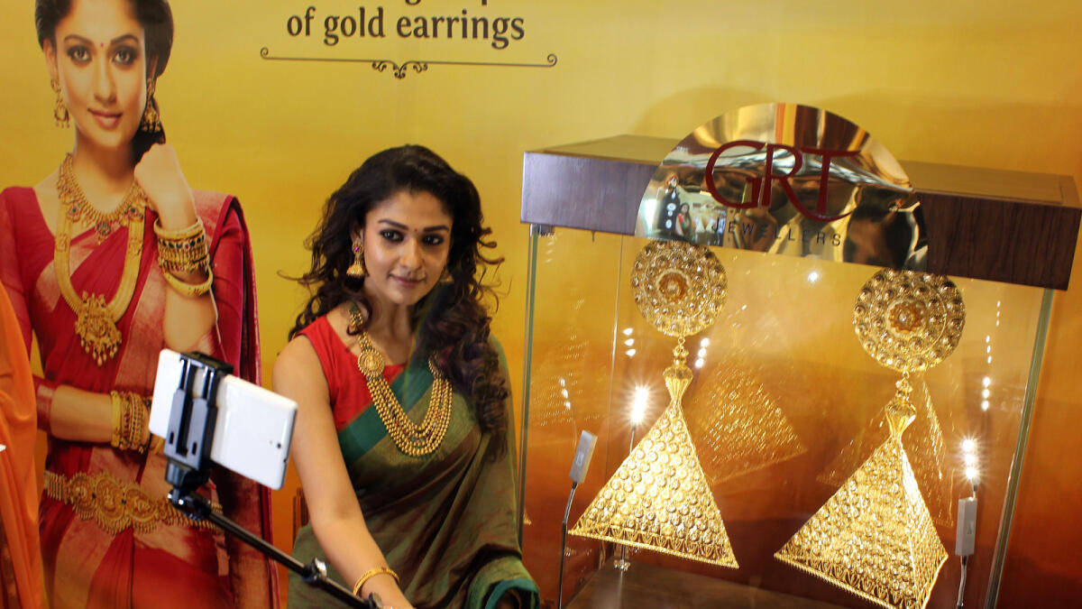 Nayantara, the Indian film actress takes a selfie with 1kg gold earrings during its exclusive preview at GRT jewellers located in Al Karama, Dubai. -Photo by Shihab/Khaleej Times