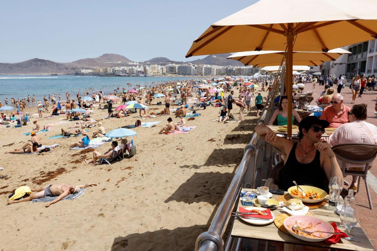Tourists eat on a terrace next to Las Canteras Beach in Las Palmas de Gran Canaria. Spain, on April 13, 2024. — Reuters