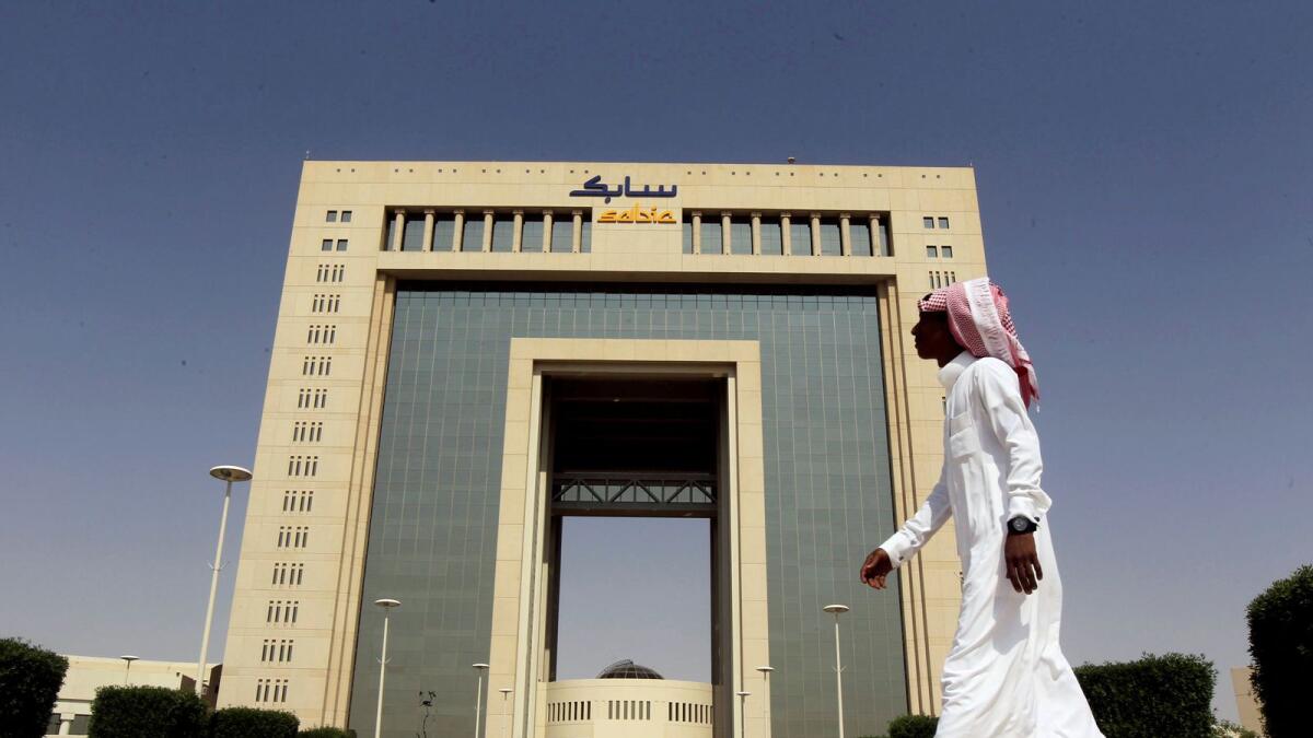 A man walks past the headquarters of Saudi Basic Industries Corp (Sabic) in Riyadh. — Reuters file photo