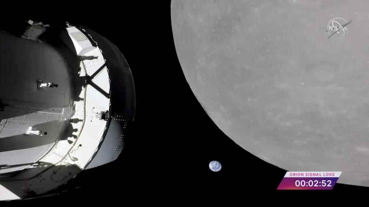 This screengrab shows Nasa's Orion capsule, left, nearing the moon, right, on Monday. — AP