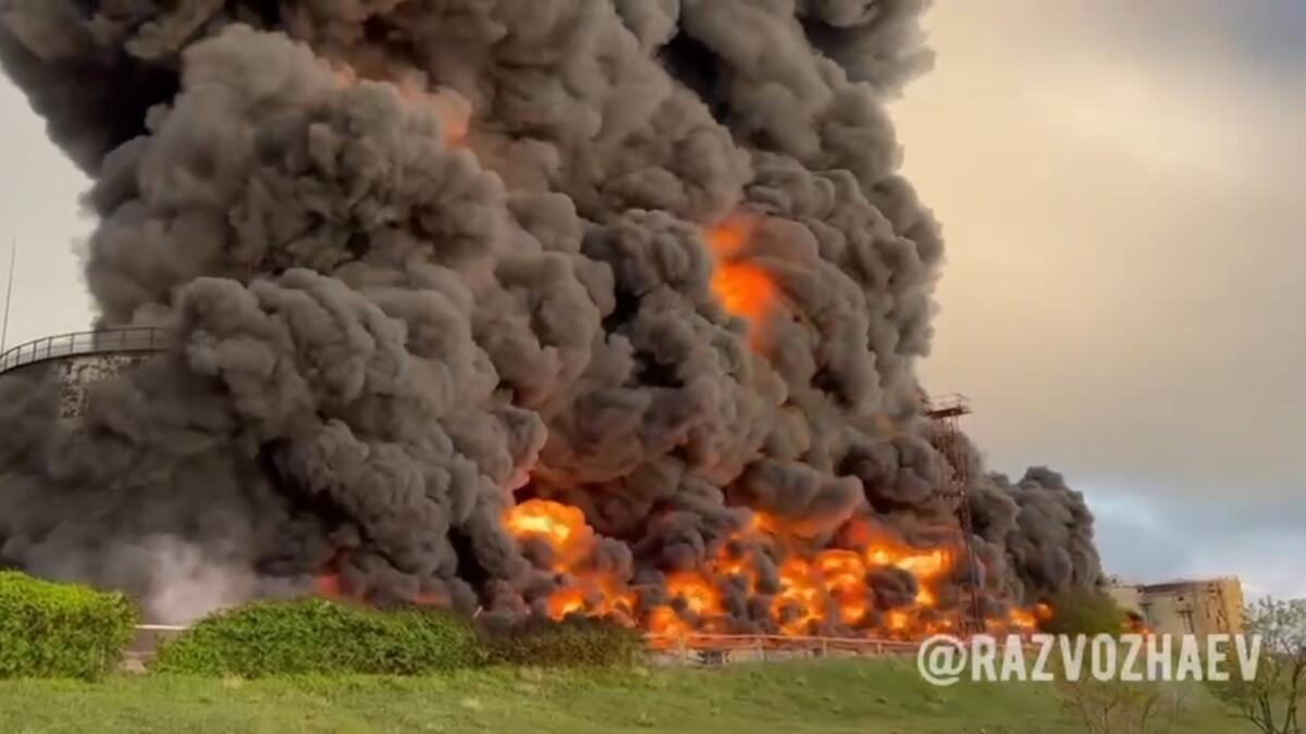 Smoke and flame rise from a burning fuel tank in Sevastopol, Crimea. — AP