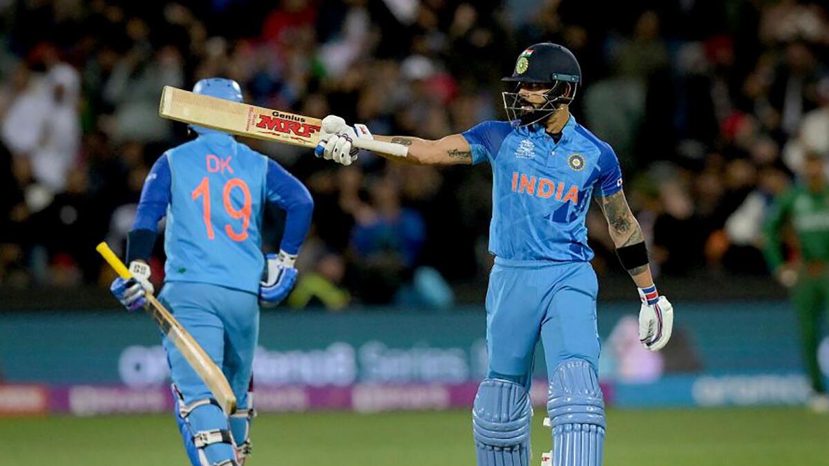 India's Virat Kohli raises his bat after scoring a half-century during the ICC Men's T20 World Cup cricket match between India and Bangladesh, at Adelaide Oval stadium. – PTI